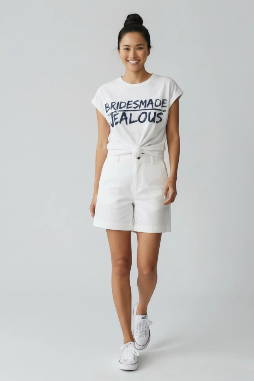Woman in Jealous Tee white t-shirt with BRIDESMADE design  by JealousTee and white shorts