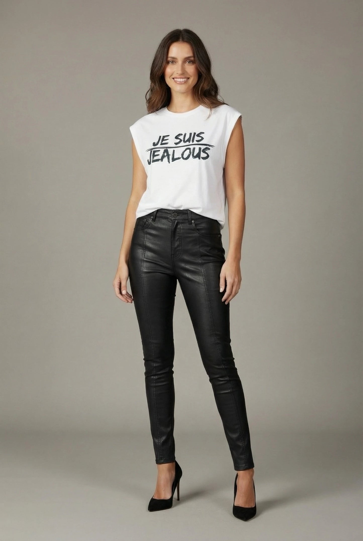Woman wearing Jealous Tee JE SUIS white progressive women's empowerment tee and black leather pants 