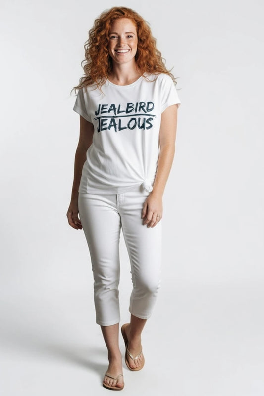 Woman wearing JEALBIRD JEALOUS progressive muscle tee and white jeans