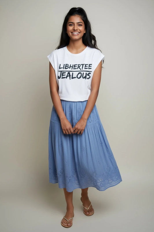 Woman wearing LIBHERTEE JEALOUS progressive muscle tee and skirt