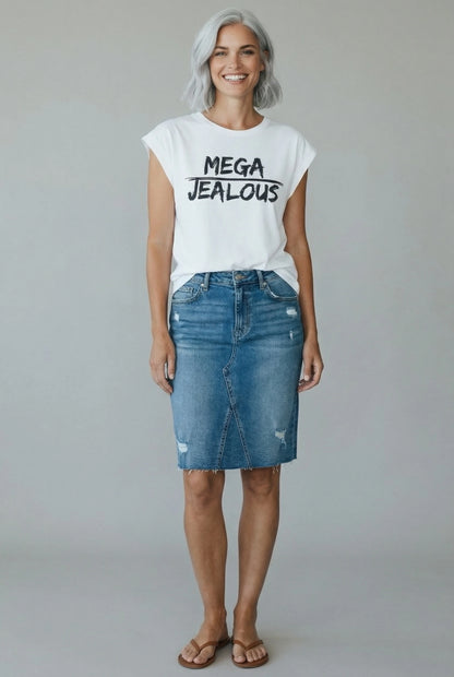 Woman wearing a white muscle t-shirt with MEGA JEALOUS design and a denim skirt