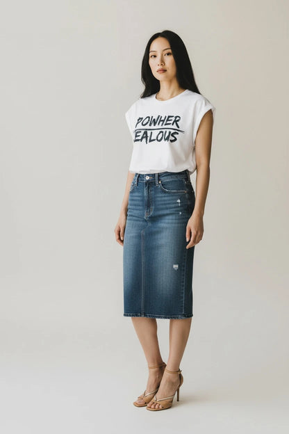 Woman wearing POWHER JEALOUS progressive muscle tee and jean skirt