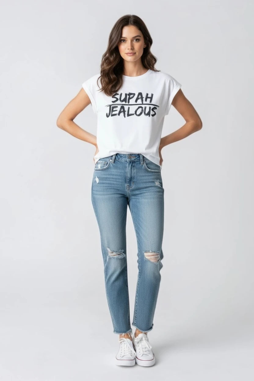 Woman wearing white sleeveless t-shirt with SUPAH JEALOUS design and light blue jeans