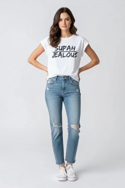 Woman wearing white sleeveless t-shirt with SUPAH JEALOUS design and light blue jeans