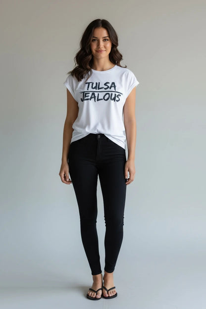 Woman wearing a white muscle t-shirt with Tulsa Jealous design